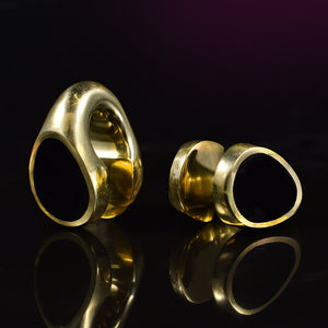 brass ear weights with black teardrop design