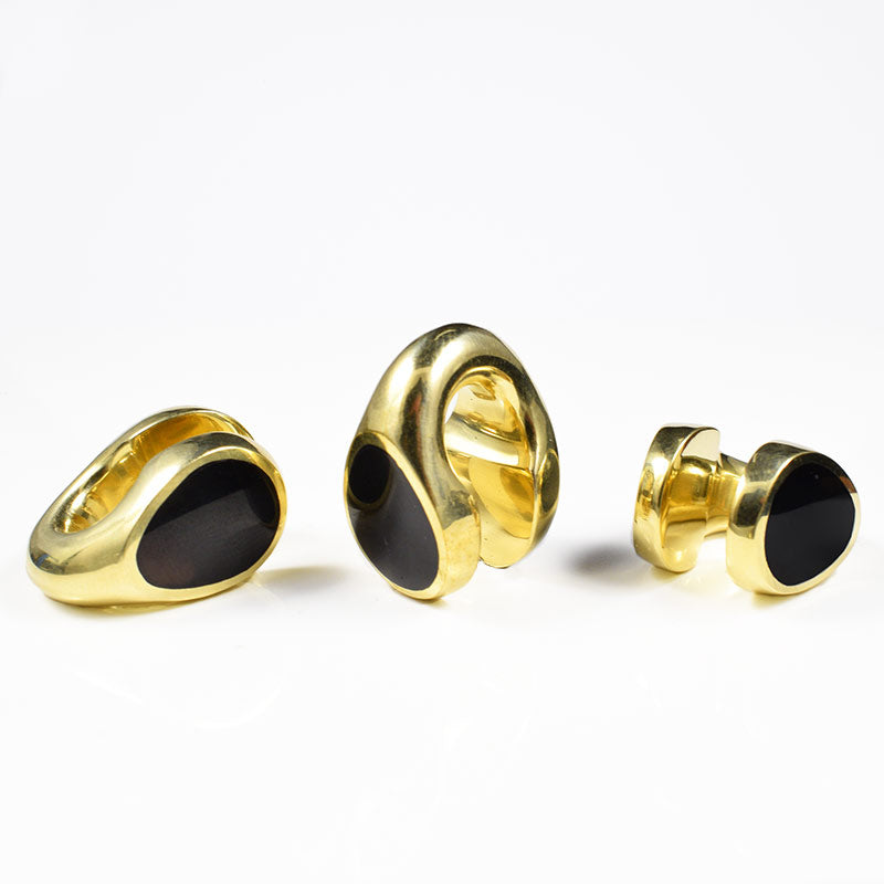 brass ear weights with black teardrop on both faces