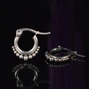 small tribal earrings with dotted hoops in surgical steel