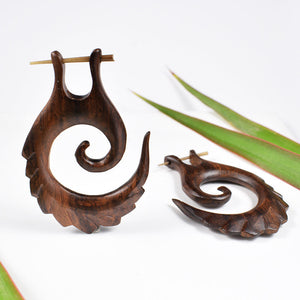 wooden stick earrings with feathered spiral design