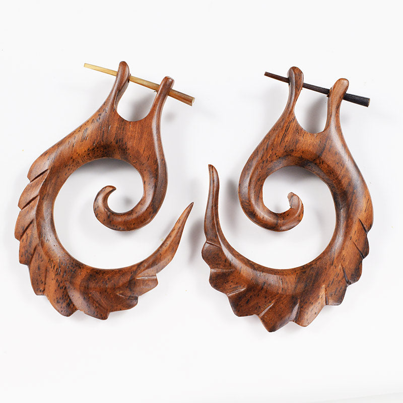 wooden stick earrings with feathered spiral design