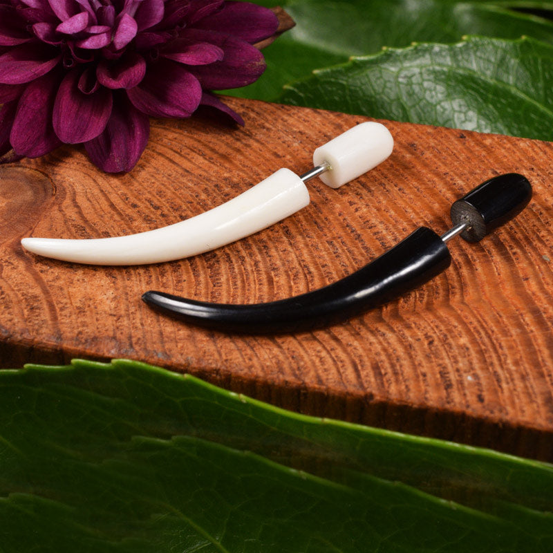 Fake ear stretchers in black and white