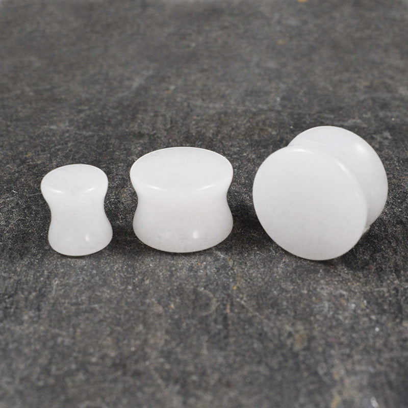 white stone flesh plugs , quartz crystal