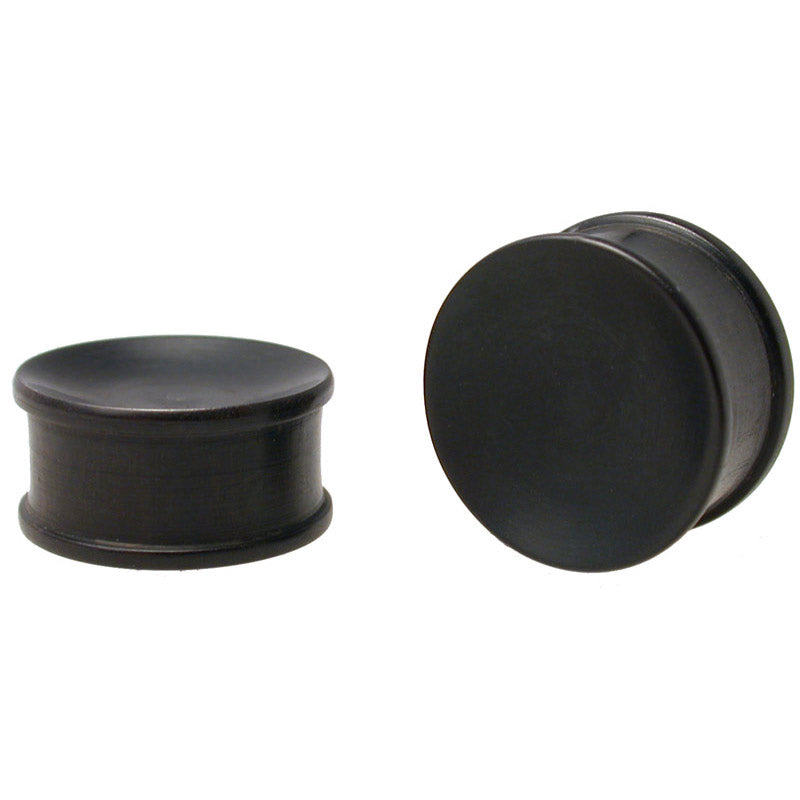 Double flared flesh plugs in black wood