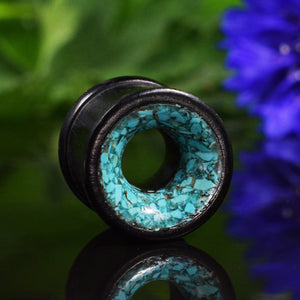 ear tunnels in wood with turquoise 
